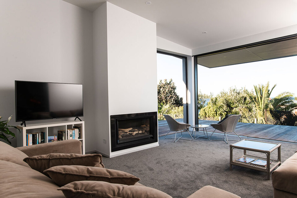 A lovely fireplace and seaside views at Beach Cove